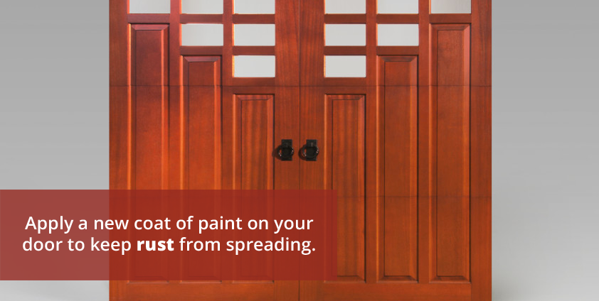 Apply a new coat of paint on garage door to keep rust from spreading.