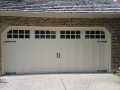 A white garage door with upper windows for natural light.