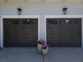 A pair of canyon ridge garage doors with upper windows for natural light.