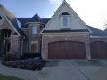 Wide-angle shot of a canyon ridge ultra grain collection garage door in walnut